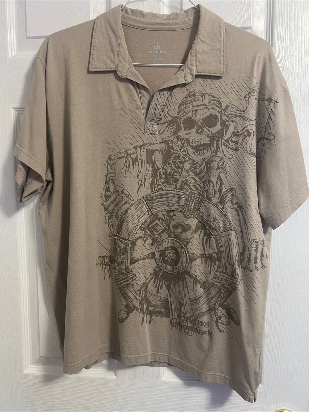 Disney Parks Men's Beige Graphic Polo with Pirate Skull Wheel